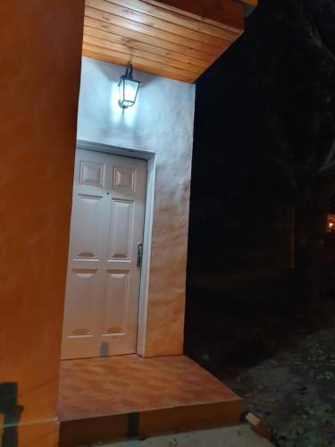 a door to a house with a light on it at Casas de Raco in Raco