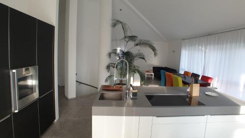 a kitchen with a sink and a living room at FeWo Püttlingen in Püttlingen