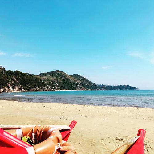 a couple of lawn chairs on a beach at Grand Hotel Il Ninfeo in Gaeta