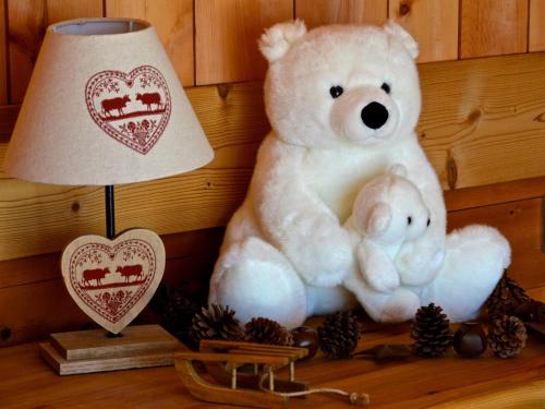 a large white teddy bear sitting next to a lamp at Hôtel Serre Palas in Les Deux Alpes
