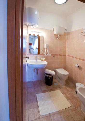a bathroom with a sink and a toilet at Casale la Rovere in Montalto di Castro