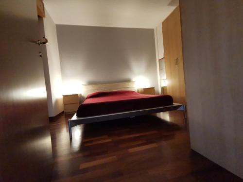 a bedroom with a bed with a red blanket at Pisco Home in Milan