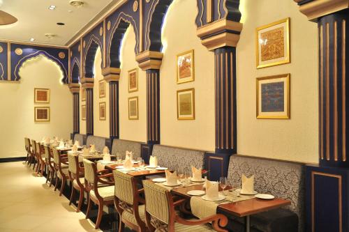 a row of tables and chairs in a restaurant at Mysore County Retreat in Mysore