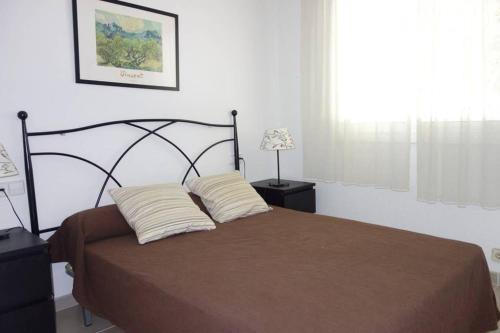 a bedroom with a bed with two pillows on it at VILLA LOS TRES SOLES in Les tres Cales