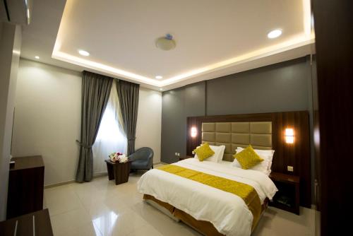a hotel room with a large bed and a window at Al Nakhla Aparthotel in Al Hofuf