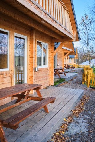 a picnic table on a deck outside of a cabin at Osada Kryspinów in Cholerzyn