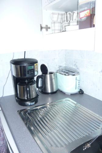 a kitchen counter with a coffee maker and a sink at les terrasses2 in Ostend