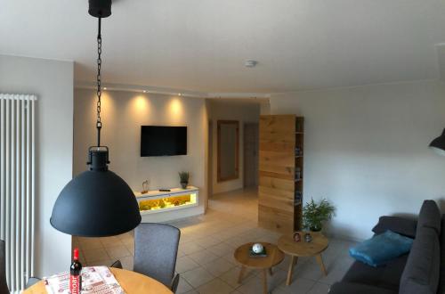 a living room with a couch and a table at An den Bergwiesen in Winterberg
