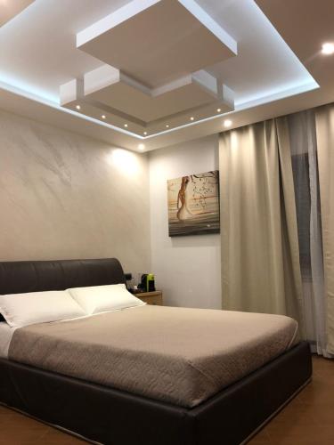 a bedroom with a bed and a ceiling at B&B Rossini Luxury 2 in Cosenza