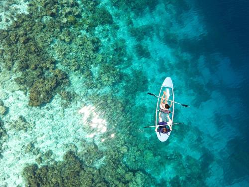 two people on a boat in the water at Eriyadu Island Resort in Reethi Rah