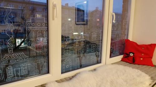 a window with a view of a city at Elen White Apartment in Rēzekne