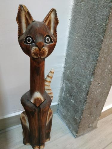 a wooden cat statue sitting on the floor at CASA ANNIO Holiday Viterbo in Viterbo