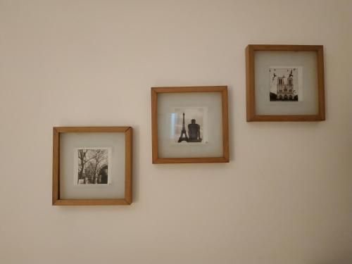 three framed pictures on a white wall at CASA ANNIO Holiday Viterbo in Viterbo