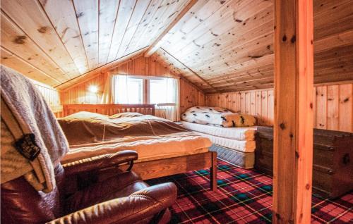 a bedroom with two beds in a wooden cabin at Beautiful Home In Rendalen With 3 Bedrooms And Wifi in Rendalen