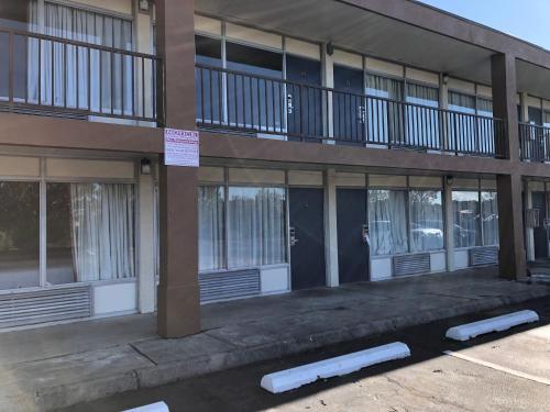 a building with a lot of windows on it at Americas Best Value Inn - Wilson in Wilson