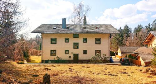 a large white house on top of a hill at Arber Apartments - Zwieslerwaldhaus in Lindberg