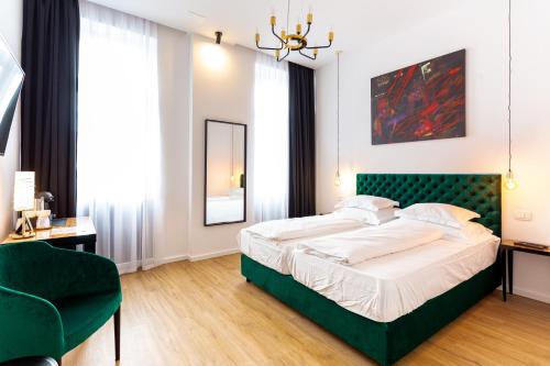 a bedroom with a large bed with a green headboard at SmartRoomsZagreb in Zagreb