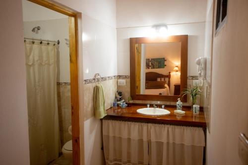 a bathroom with a sink and a mirror at Cabañas El Vallecito in Villa del Dique