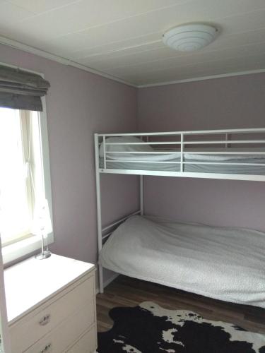 a bedroom with two bunk beds and a window at Summer haus in Syreflot