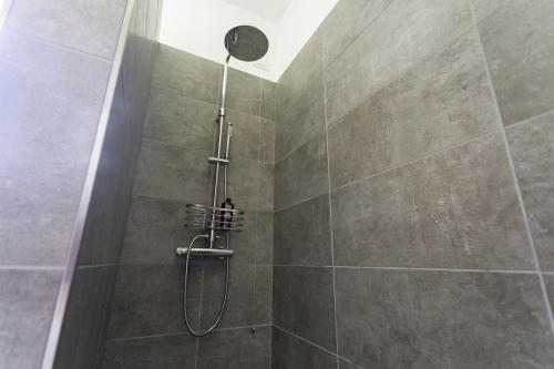 a shower with a shower head in a bathroom at Aqua&Co Bellagio - Eco conscious stay in Bellagio