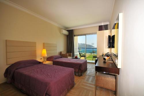 a hotel room with two beds and a balcony at Blue Bay Platinum in Marmaris