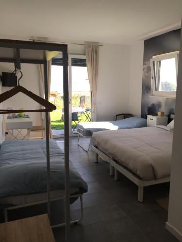 a bedroom with two beds and a balcony at Aqua&Co Bellagio - Eco conscious stay in Bellagio