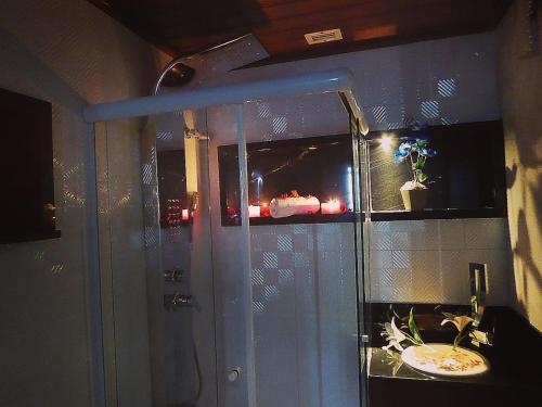 a bathroom with a sink and a glass door at Sol Victoria Marina Lofts in Salvador