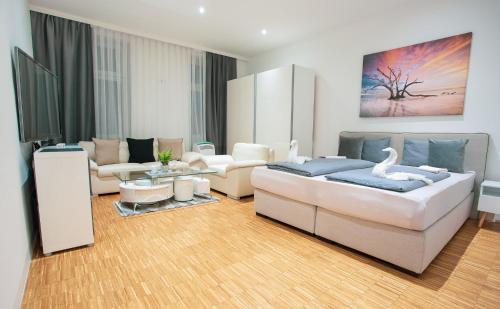 a living room with a large bed and a couch at 1020 | VIE | Apartment in Vienna