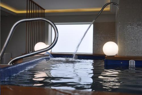 an indoor swimming pool with a water slide at Hostal Meson Leira Antiga in Cedeira