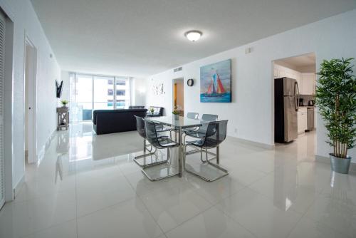 a dining room and living room with a table and chairs at Paradise on Hollywood Beach 2 bed 2 bath in Hollywood