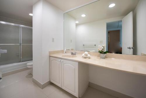a bathroom with a sink and a mirror and a toilet at Paradise on Hollywood Beach 2 bed 2 bath in Hollywood