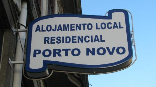 a street sign with a blue and white sign on it at Residencial Porto Novo - Alojamento Local in Porto