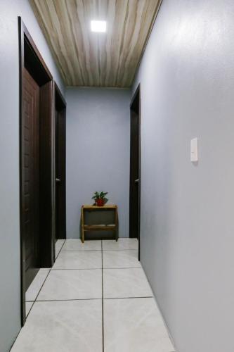 a hallway with black doors and a tile floor at Casa Suculenta ,Monteverde con Jacuzzi Privado y Lavandería in Monteverde Costa Rica