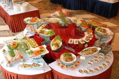 a buffet table with a lot of food on it at Mysore County Retreat in Mysore