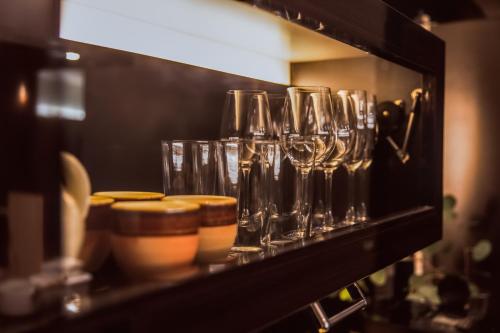 a shelf with wine glasses on it at ITADAKI Daisen 大山参道ホテル頂 in Daisen