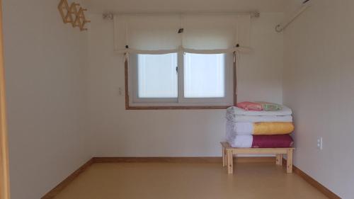 a room with a pile of towels on a table at Moonlight House in Cheongsong