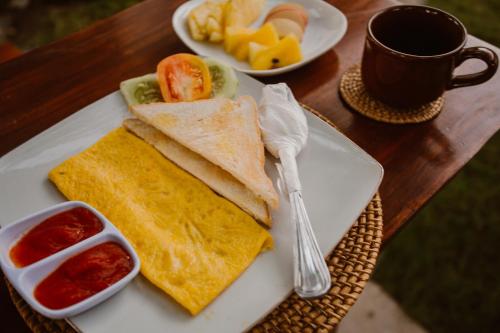 a plate of food with a sandwich and a cup of coffee at Abian Selumbung Bungalow in Nusa Penida