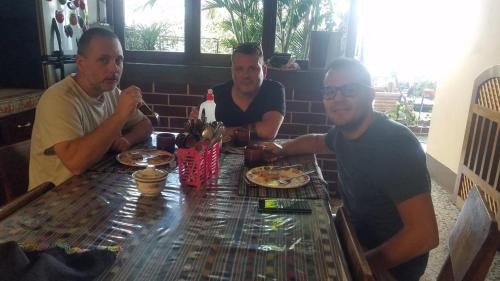 a group of three men sitting at a table at Casa Guillermo Batz in San Pedro La Laguna
