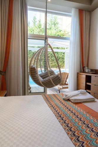 a bedroom with a hammock hanging from a bed at Side Royal Palace in Side