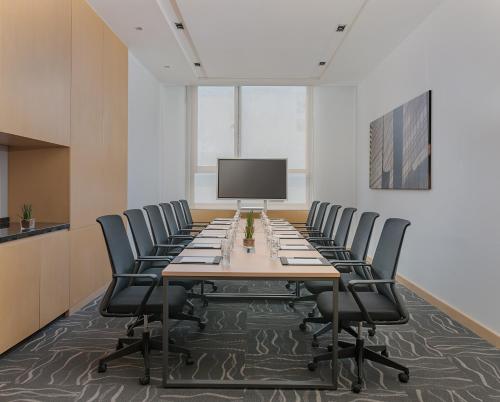 a large conference room with a long table and chairs at Seda Bonifacio Global City in Manila