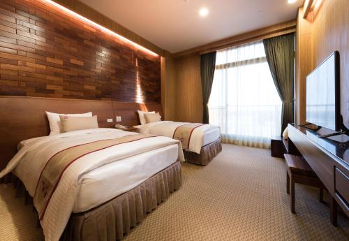 Ένα ή περισσότερα κρεβάτια σε δωμάτιο στο Shandori Hotel