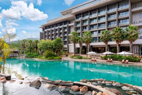 a swimming pool in front of a hotel at Gran Melia Arusha in Arusha