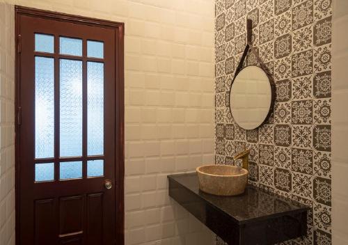 a bathroom with a sink and a mirror at Le Printemps d' An Bang in Hoi An