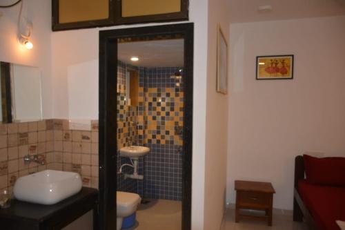 a bathroom with a shower and a toilet and a sink at DSK Studio Apartment, Siolim, Goa. in Siolim