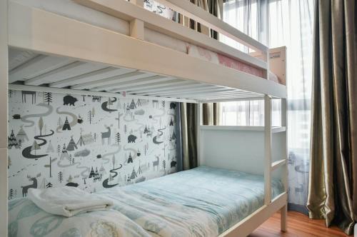 a childs bedroom with bunk beds and a wall with asian characters at Q Suite at i-City in Shah Alam