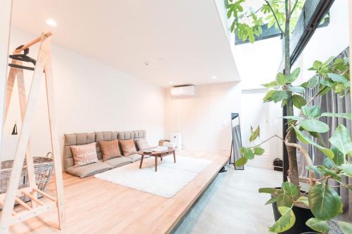a living room with a couch and lots of plants at 谷町君 星屋 八尾家 京都清水五条 in Kyoto