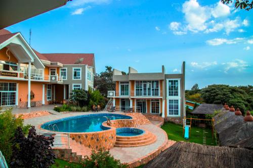 a house with a swimming pool in the yard at Masailand Safari Lodge in Arusha