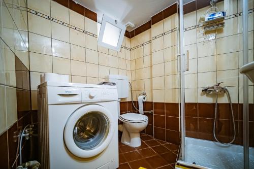 a bathroom with a washing machine and a toilet at 2 Bedrooms-Perfect Center Location-Amazing View in Ioannina