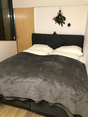 a bedroom with a large bed with a wreath on the wall at EMMA'S Appartements in Gerlos