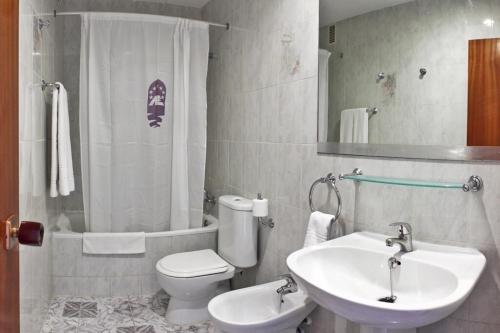 a bathroom with a sink and a toilet and a shower at Europa Family Apartments in Blanes